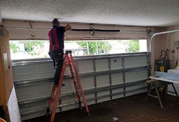 Checking and adjusting spring tension during new garage door spring installation in Coral Springs