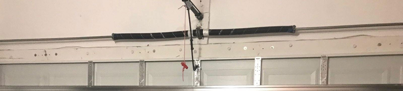 Checking and adjusting spring tension during new garage door spring installation in Coral Springs
