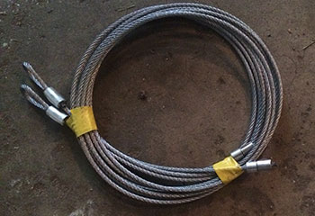 Broken garage door cable near drum assembly and ceiling mount in Parkland, FL garage