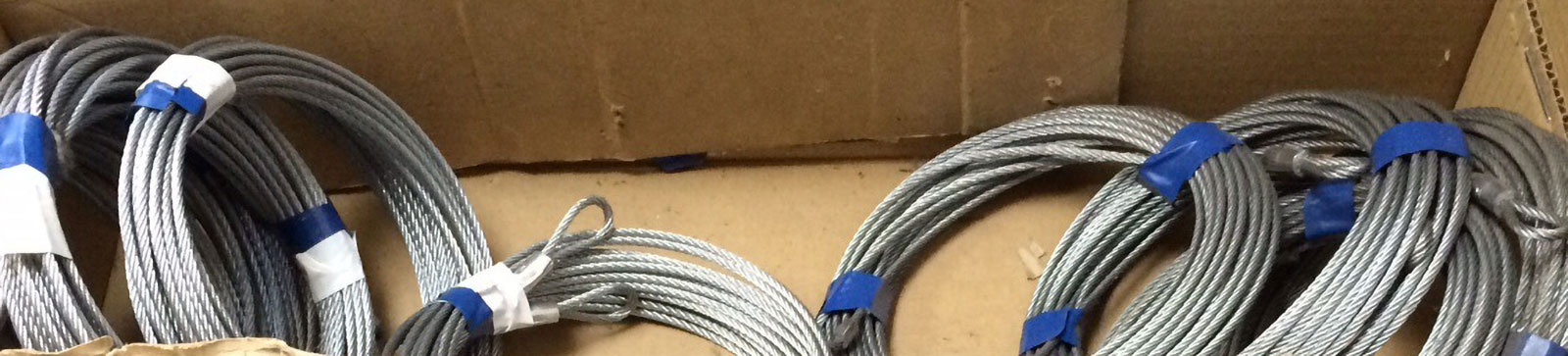 Broken garage door cable near drum assembly and ceiling mount in Parkland, FL garage